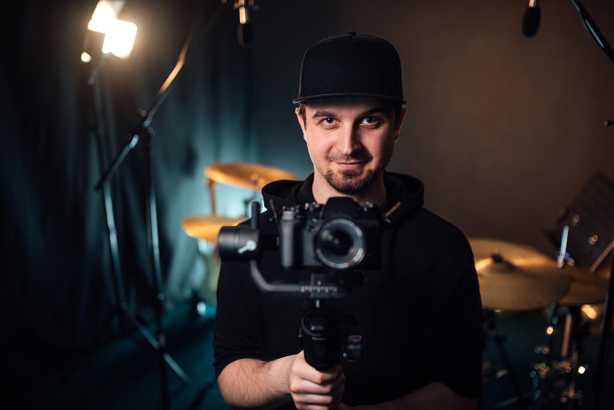 young-professional-videographer-holding-camera-on-resize.jpg